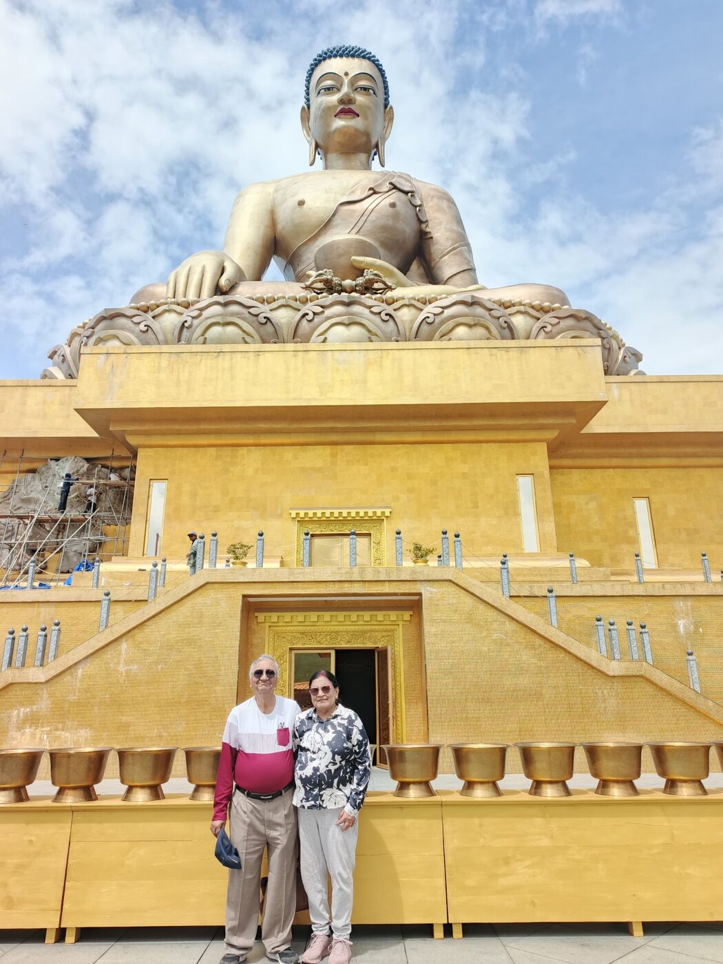 Two travellers at the golden Buddha Dordenma statue in Thimphu, Bhutan